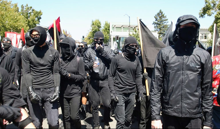 Black-clad Antifa marchers arrive at Civic Center Park, Sunday, Aug. 27, 2017, in a counter-protest against a planned alt-right rally in Berkeley, California. (Karl Mondon/Bay Area News Group)